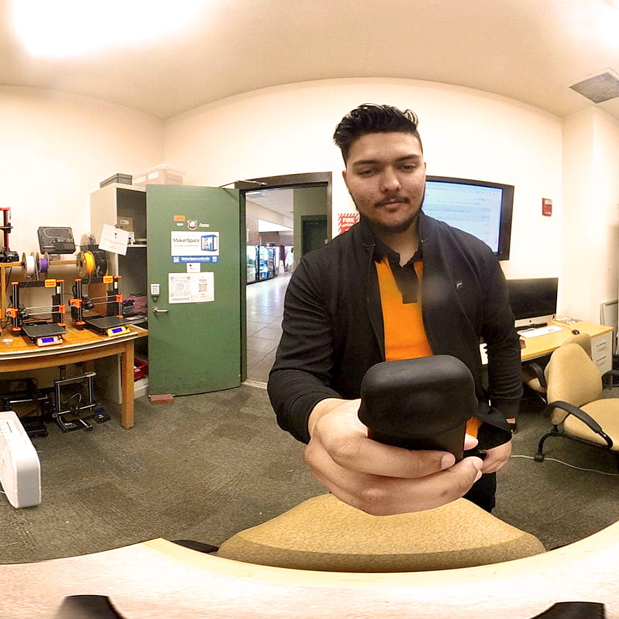 student Mustafa Mohammed holds 3D camera in lab.